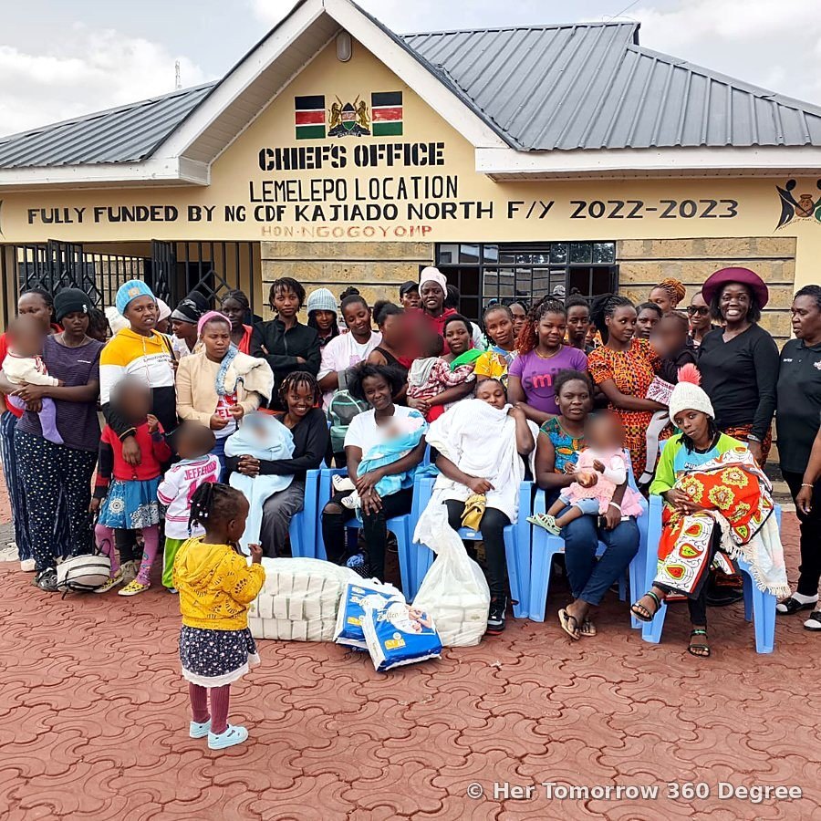 Mothers and children gathered outside the Chief's Office, Lemelepo, with bags of donated items